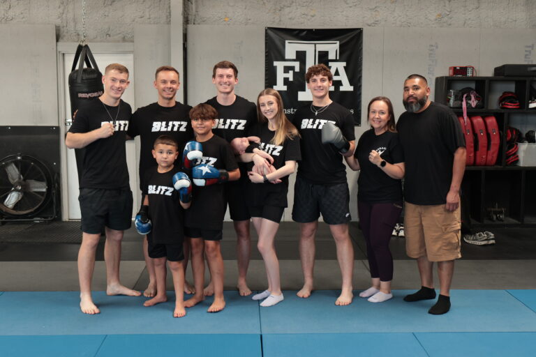 Blitz Martial Arts team alongside happy students.