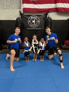 Sensei Tyce and Daygan next to the Little Ninjas after completing the belt test.