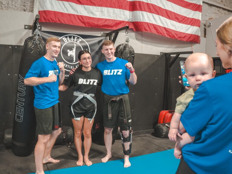 Sensei Daygan and Tyce with adult mma student, baby Zayd judges you from the sidelines.